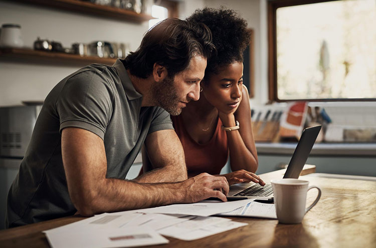couple with laptop doing paper work