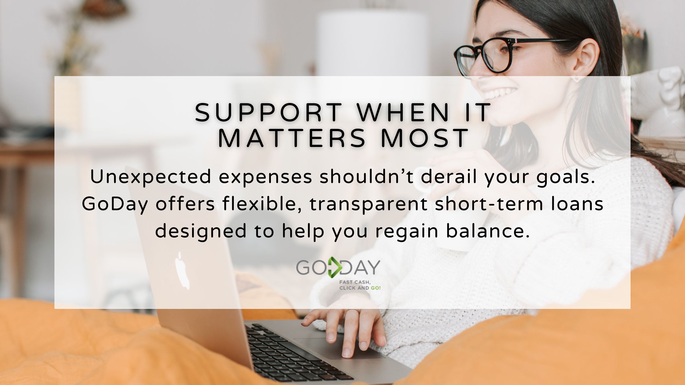 Smiling woman using a laptop at home, highlighting GoDay’s transparent short-term loan options that provide financial support during unexpected expenses.